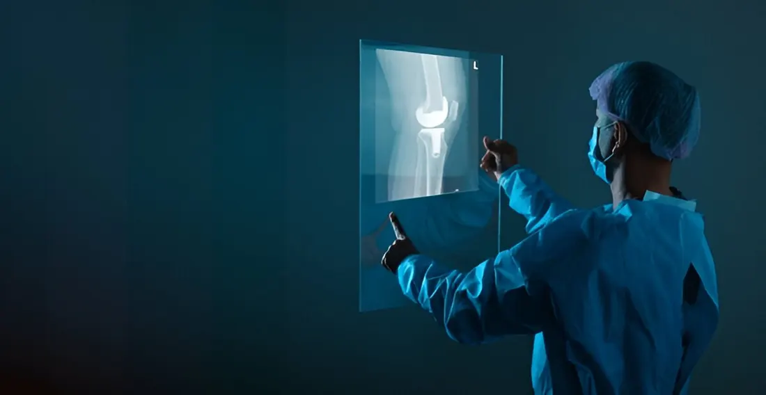 Doctor reviewing a spine X-ray — back and neck pain assessment